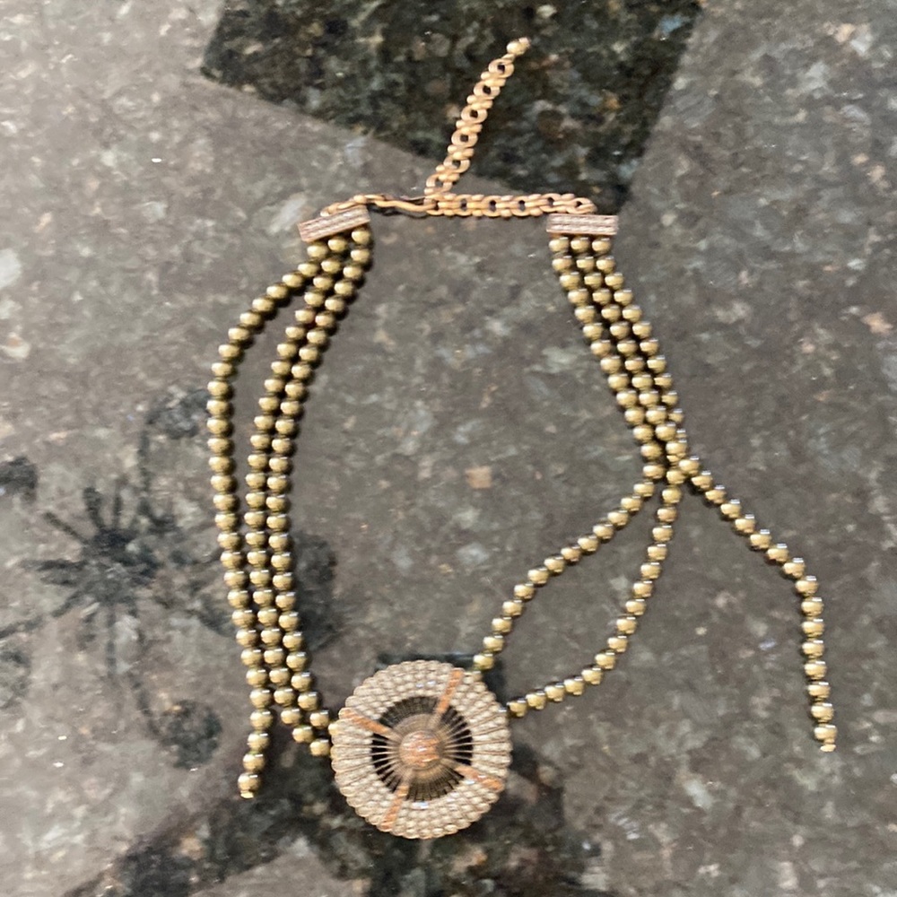 Heidi Daus Designer golden needs with rhinestone medallions.